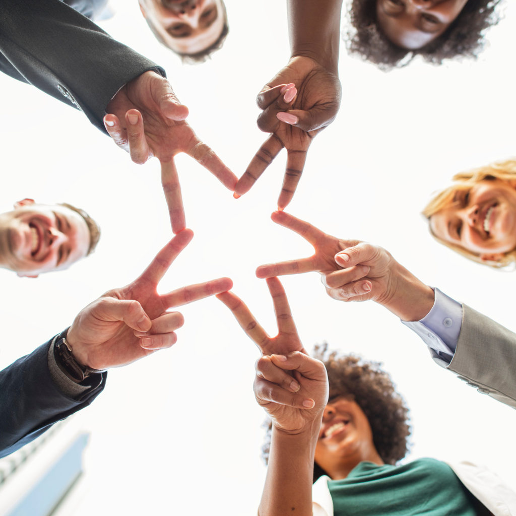 adult business men forming a star with fingers connecting